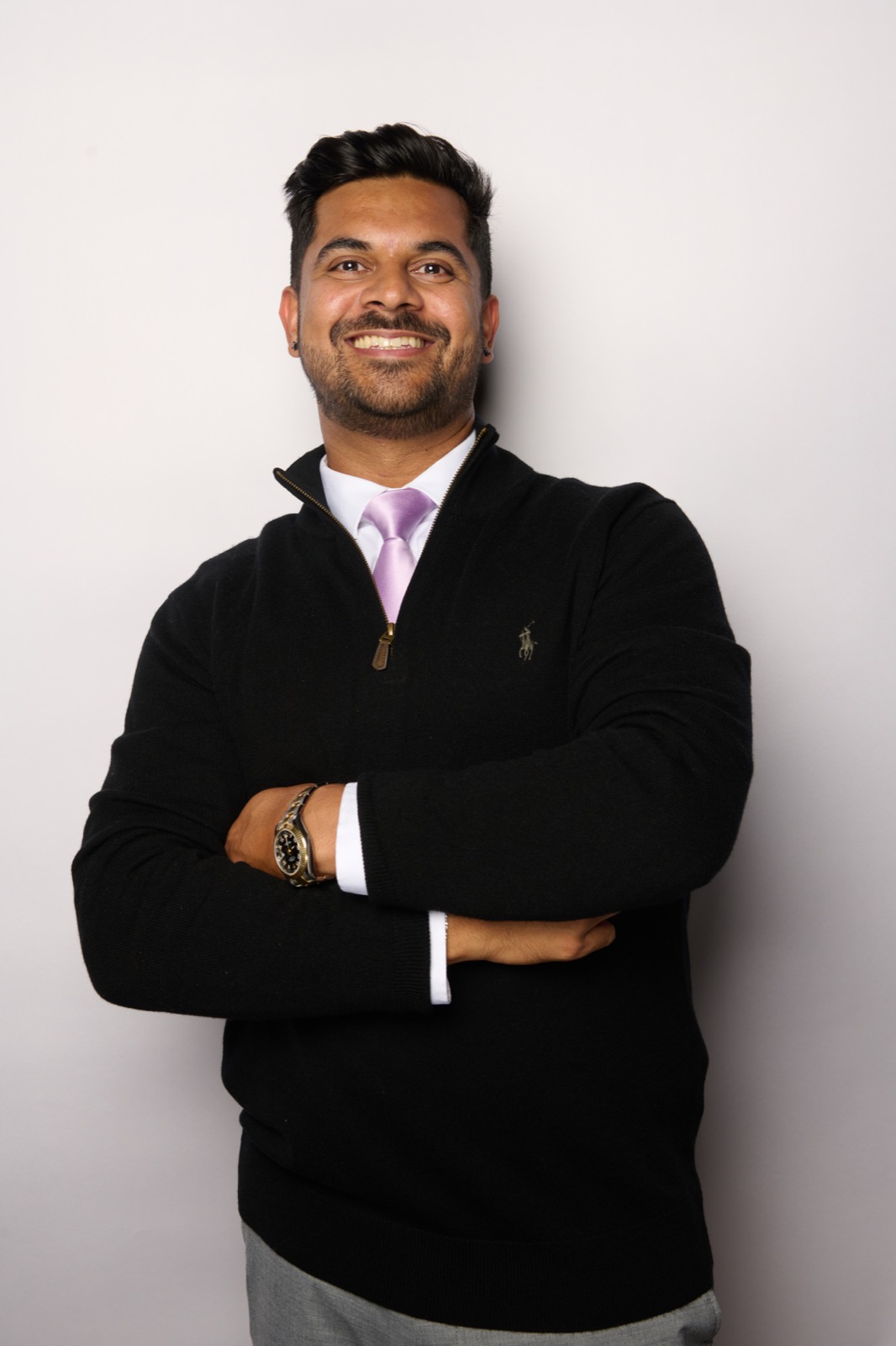 Sabeel Siddiqi smiling with his arms folded